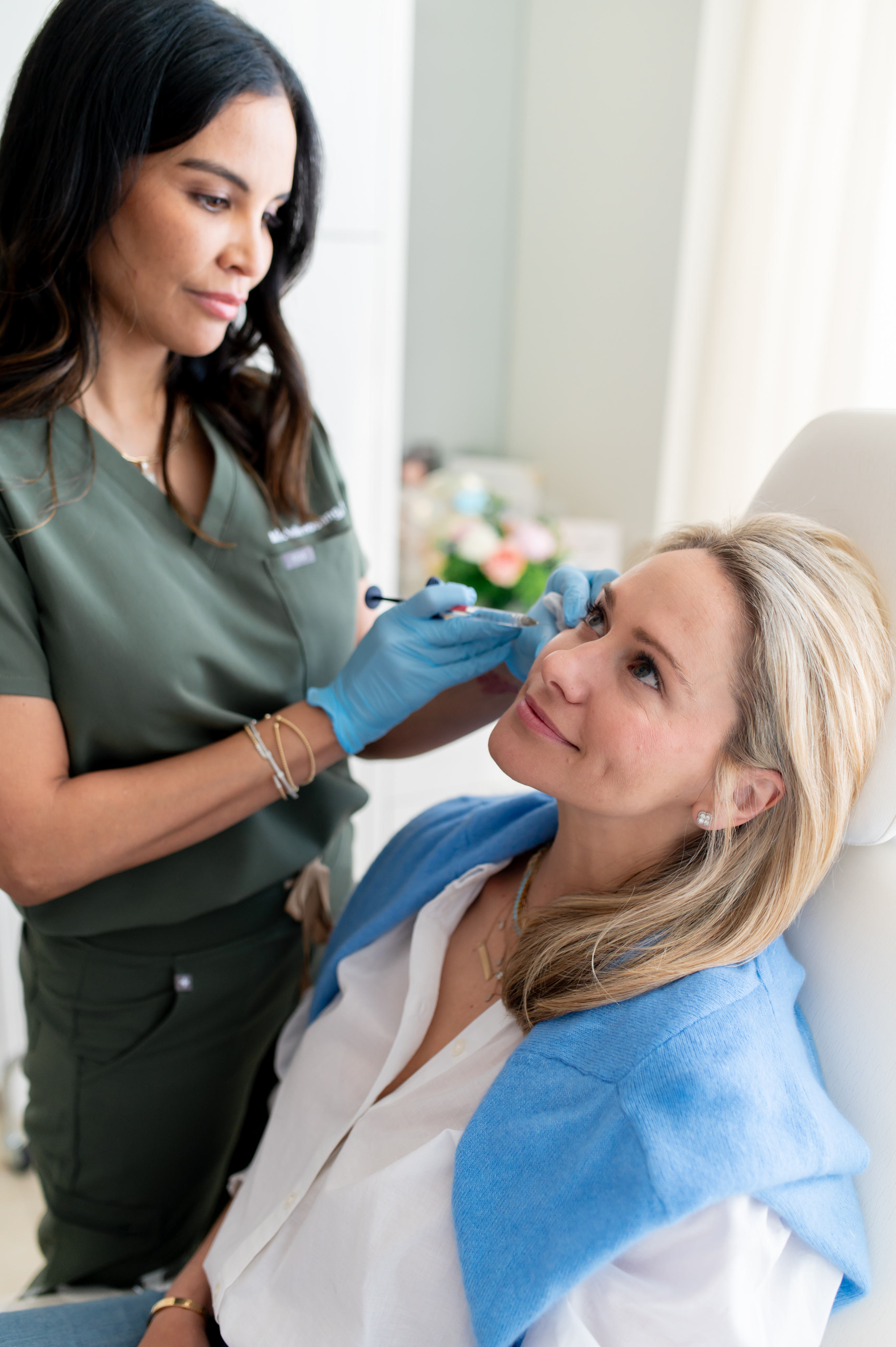 Specialist administering injectable treatment to patient